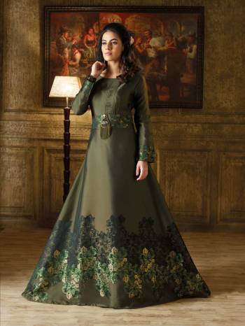 New And Unique Shade In Green Is Here With This Designer Floor Length Gown In Forest Green Color Based On Imported Fabric. It Has Lovely Self Prints And A Broach Over The Belt. 