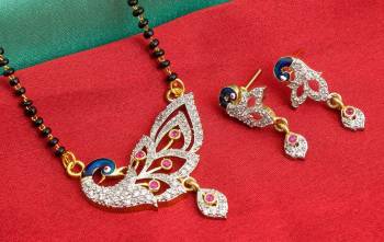 Grab This Designer Heavy Mangalsutra In Golden Color Beautified With Diamonds All Over. This Mangalsutra Comes With A Set Of Matching Earrings. It Is Light In Weight And Easy To Carry Throughout The Gala.  Buy Now.