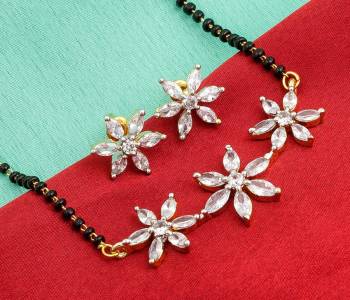 Grab This Designer Heavy Mangalsutra In Golden Color Beautified With Diamonds All Over. This Mangalsutra Comes With A Set Of Matching Earrings. It Is Light In Weight And Easy To Carry Throughout The Gala.  Buy Now.