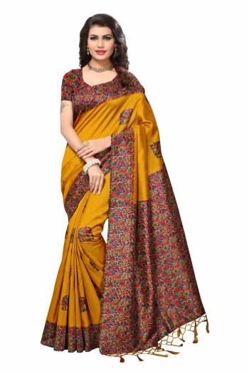 Celebrate This Festive Season With Beauty And Comfort Wearing This Saree In Musturd Yellow Color Paired With Contrasting Red Colored Blouse. This Saree And Blouse Are Fabricated On Kashmiri Art Silk Beautified With Floral Prints Over The Border And Blouse.