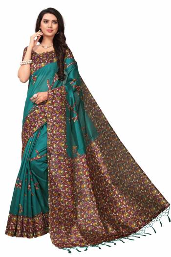 New Shade In Blue Is Here With This Silk Saree In Teal Blue Color Paired With Contrasting Magenta Pink Colored Blouse. This Saree And Blouse Are Fabricated On Kashmiri Art Silk Beautified With Multi Colored Floral Prints. 