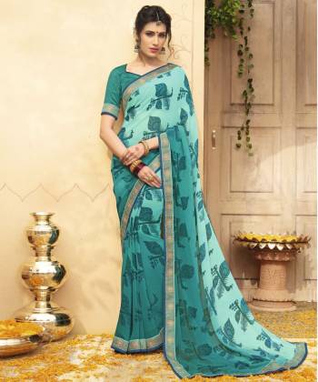 Go With The Shades Of Blue Wearing this Saree In Aqua Blue Color Paired With Teal Blue Colored Blouse. This Saree And Blouse Are Fabricated On Georgette Beautified With Pretty Unique Motif Prints. Buy This Saree Now.