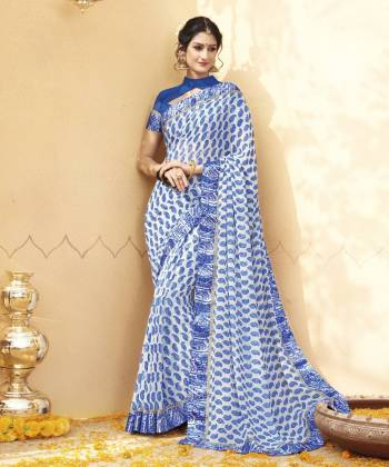 Pretty Simple And Elegant Looking Saree Is Here In White And Blue Color Paired With Blue Colored Blouse. This Saree And Blouse Are Fabricated On Georgette Beautified With Paisly Prints All Over It. Buy This Saree Now.