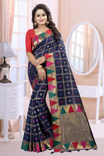 Add This Lovely Saree To Your Wardrobe In Navy Blue Color Paired With Red Colored Blouse. This Saree And Blouse Are Fabricated On Linen Beautified With Prints. It Is Light Weight And Easy To Carry All Day Long.