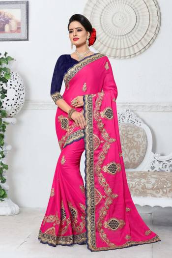 Look Pretty Wearing This Saree In Pink Color Paired With Contrasting Navy Blue Colored Blouse. This Saree Is Fabricated On Silk Paired With Art Silk Fabricated Blouse. It Has Lovely Embroidery All Over The Saree. 