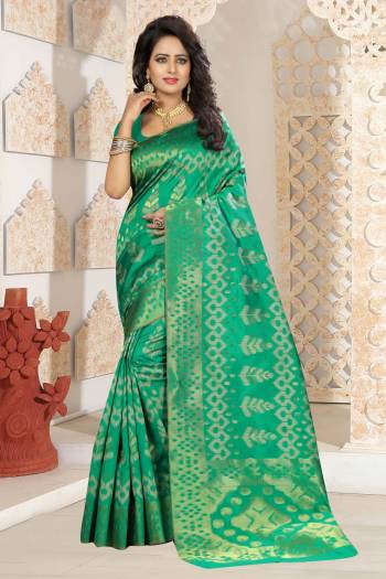 Grab This Rich Looking Silk Saree In Green Color Paired With Green Colored Blouse. This Saree And Blouse Are Fabricated On Kanjivaram Art Silk Beautified With Weave. Buy ThiS Saree Now.