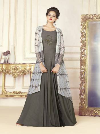 Flaunt Your Rich And Elegant Taste Wearing This Designer Readymade Gown In Grey Color. Its Top Is Fabricated On Cotton Blend Paired With Chanderi Cotton Fabricated Printed Jacket. It Has An Attractive Pipe Work Patch Over The Front. Buy This Designer Indo-Western Dress Now.