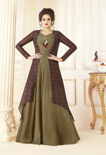 Here Is A Beautiful Designer Readymade Gown Suitable For All Occasion. Grab This Designer Gown In Olive Green Color With Multi Colored Jacket. It Is Cotton Blend Fabricated With Chanderi Cotton Fabricated Jacket. Buy This Gown Now.