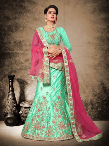 Add This Lovely Shade In Green To Your Wardrobe With This Heavy Designer Lehenga Choli In Sea Green Color Paired With Contrasting Rani Pink Colored Dupatta. Its Blouse And Lehenga Are Fabricated On Velvet Satin Paired With Net Fabricated Dupatta. 