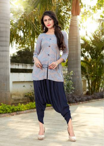 You Will Get A Designer Look Wearing this Lovely Pair In Grey Colored Kurti Paired With Navy Blue Colored Bottom. This Kurti And Dhoti Are Fabricated On Rayon Which Is Light Weight And Easy To Carry All Day Long.