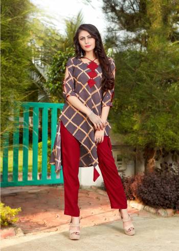 Unique Patterned Designer Readymade Kurti Is Here In Dark Grey Color Paired With Contrasting Red Colored Bottom. This Kurti And Pants Are Fabricated On Rayon And Available In All Regular Sizes. Buy This Pair Now.