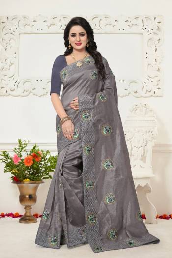 Flaunt Your Rich And Elegant Look Wearing This Designer Saree In Grey Color Paired With Grey Colored Blouse. This Saree Is Fabricated On Oragenza Paired With Art Silk Fabricated Blouse. It Has Pretty Contrasting Embroidery Over The Saree.