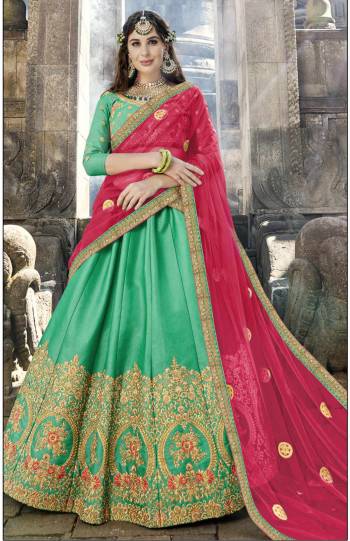 Add This Beautiful Designer Lehenga Choli In Sea Green Color Paired With Contrasting Dark Pink Colored Blouse. This Lehenga Choli Is Fabricated On Soft Silk Paired With Chiffon Fabricated Dupatta. It Is Beautified With Jari Embroidery And Stone Work.