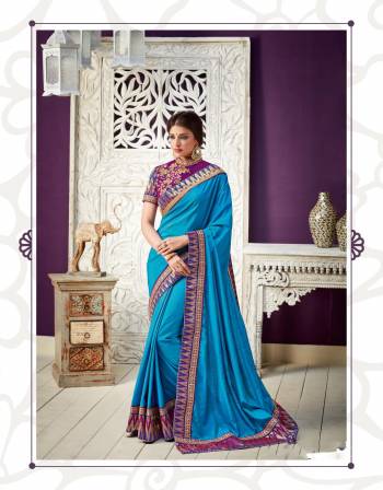 Add vibrancy to your look this season in this vivid turquoise blue color blocked saree adorned with temple motifs. Compliment it with simple jewels for a maximal outlook. 