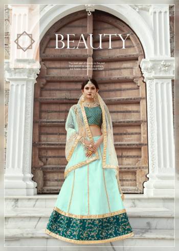 Featuring An Aqua Colored art silk lehenga with zari work and sequins work on hem. It comes along with a Teal Blue blouse in art silk base with shot sleeves featuring heavy zari and sequins embroidery on whole blouse. It has a soft net dupatta with seuqins lining.