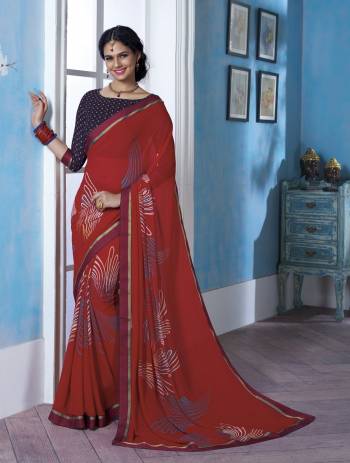 Adorn the Pretty Angelic Look Wearing This Attractive And Elegant Red Colored Saree Paired With Contrasting Navy Blue Colored Blouse. This Saree And Blouse Are Fabricated On Georgette Beautified With Prints.