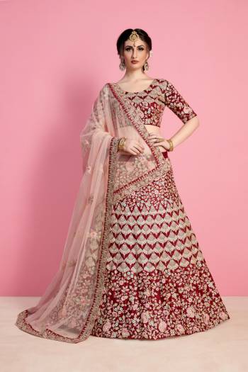 For A Royal Queen Like Look, Grab This Heavy Designer Lehenga Choli In Maroon Color Paired With Light Pink Colored Dupatta. Its Blouse And Lehenga Are Fabricated On Velvet Silk Paired With Net Fabricated Dupatta. Its All Over Heavy Embroidery And Pretty C