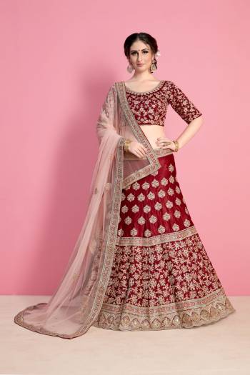 For A Royal Queen Like Look, Grab This Heavy Designer Lehenga Choli In Maroon Color Paired With Light Pink Colored Dupatta. Its Blouse And Lehenga Are Fabricated On Velvet Silk Paired With Net Fabricated Dupatta. Its All Over Heavy Embroidery And Pretty C