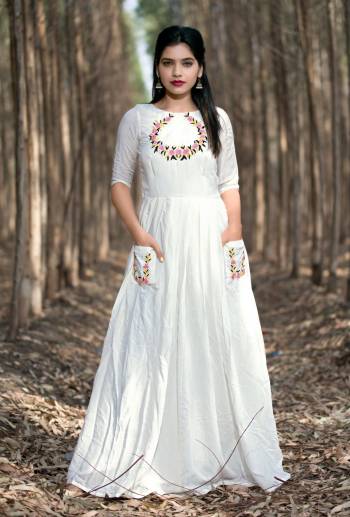 White Color Muslin Silk Fabric Kurti. This kurti featuring of beautiful floral handwork in yoke and pockets  . This attractive kurta will surely fetch you compliments for your rich sense of style.