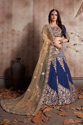 This set features a navy blue colour blouse in art silk base with zari and thread hibiscus leafs embroidery all over the front and back. It is paired with matching navy blue flared art silk lehenga appliqued with hibiscus embroidery all over the ghera.