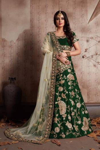 Dark Green velvet lehenga with zari embroidery highlighted with topaz crystals paired with a Light Green dupatta, with a machine embroidered border.