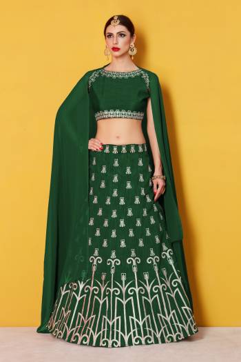 Featuring a Dark green blouse in art silk with silver gold embroidery and it comes along with Dark green lehenga in art silk. It is paired with Dark green plain dupatta in Georgette