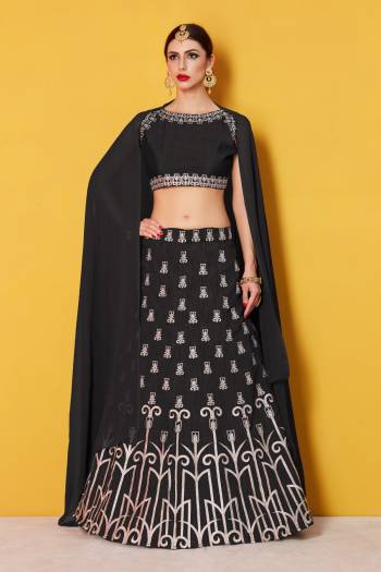 Featuring a Black blouse in art silk with silver gold embroidery and it comes along with black lehenga in art silk. It is paired with black plain dupatta in chanderi.