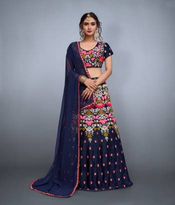 Look no less than any celebrity in this bridesmaids lehenga. The navy blue colored velvet lehenga and choli is enhanced by resham,mirror & zari embroidery in the form of contemporary motifs.