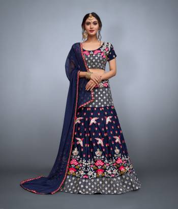 Glam up  look graceful on this wedding and festival occasion.The navy blue colored velvet choli and soft net dupatta with lavish resham embroidery and velvet flared resham, zari and mirror work embroidered lehenga. 