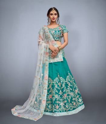 Featuring a Teal green blouse in art silk with dori work embroidery and it comes along with Teal green lehenga in art silk. It is paired with Off-White embroidered dupatta in net.