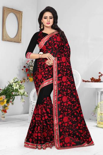 For A Bold And Beautiful Look, Grab This Georgette Based Saree In Black Color Paired With Black Colored Blouse Beautified With Heavy Red Colored Resham Work.