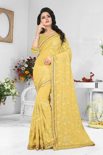 Celebrate This Festive Season Wearing This Pretty Saree In Yellow Color Paired With Yellow Colored Blouse, This Saree And Blouse Are Fabricated On Georgette Beautified With Same Tone Resham Embroidery And Stone Work. Buy This Saree Now.