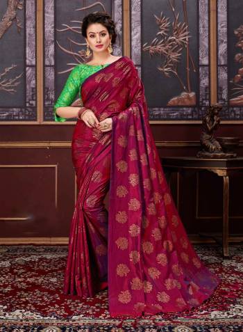 For a royal look, add this beautiful designer saree to your wardrobe in Maroon color paired with contrasting light green colored blouse. This saree is fabricated on fancy silk paired with jacquard silk fabricated blouse.  Both the fabrics ensures superb comfort all day long.