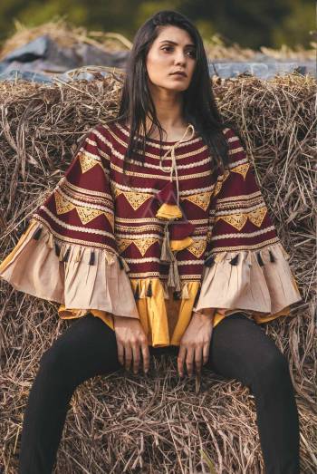 Rings with triangles embroidered  poncho on wine khadi fabric embilished with conica tassel and golden tassel lace in radius. Attached with Maroon & Yellow alternate color frill all over the poncho 