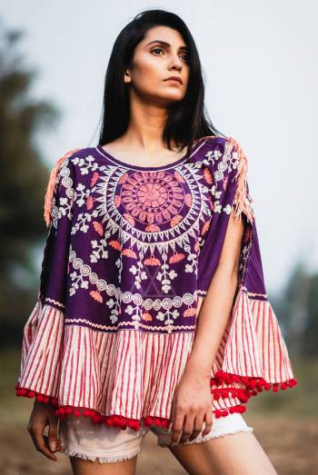 Sun embroiderd poncho in fancy way on purple khadi fabric embilished with tassel lace on shoulders and tomato pom pom in frill. Attached with lining frill all over the poncho