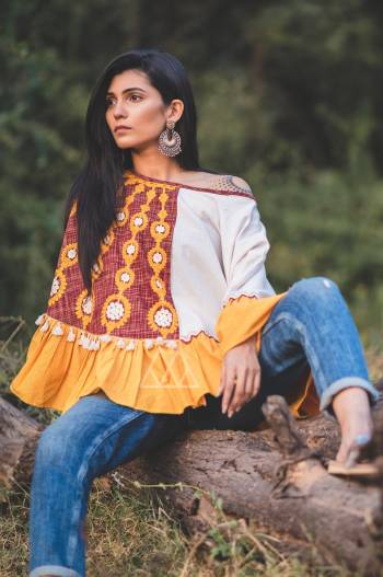 one shoulder embroidered poncho on Maroon & Yellow khadi fabric embilished with jute lace and cotton hanging lace . Attached with mustured frill all over the poncho 