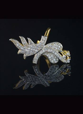 Give A Very Pretty Look To Your Soft Beautiful Hands With This Lovely Designer Ring In Golden Color Beautified With Lovely Diamond Work. This Pretty Ring Can Be Paired With Any Colored Attire. Buy Now.