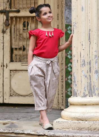 Cowl pant weaved in plain and ikat lining pattern, Ankle is sleek to give a slim look with Long length pockets on both sides, Has a back pocket also .Two flaps to tie knot at the waist, TOP - Dark Pink Colored  khadi plain top with back opening, Sleeves has long frill pattern, it has jute tassels attached on neck line. 