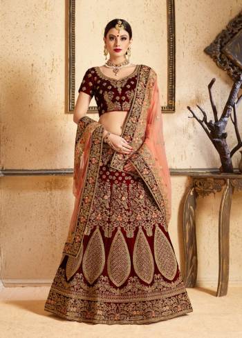 Get Ready For Your D-day With This Heavy Designer Bridal Lehenga choli In Maroon Color Paired With Contrasting Peach Colored Dupatta. This Velvet Based Lehenga And Choli Are Beautified With Heavy Jari And Resham Embroidery With Stone Work. Its Soft Net Dupatta Can Be Drape As Per It Is Suitable To You. Its Fabric Also Ensures Superb Comfort Throughout The Gala And Earn You Lots Of Compliments From Onlookers. Buy Now.