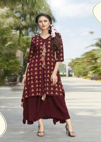 Here Is A Designer Readymade Kurti With Double Layered Pattern In Maroon Color Fabricated On Rayon Beautified With Prints. It Is Soft Towards Skin and Easy To Carry All Day Long.