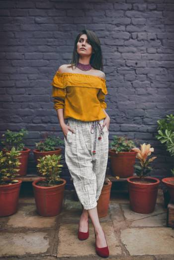 Off-White Colored khadi calf length pant with elastic at the waist and elastic at the bottom 
Paired With Musturd Yellow off shoulder top with 3/4th sleeves