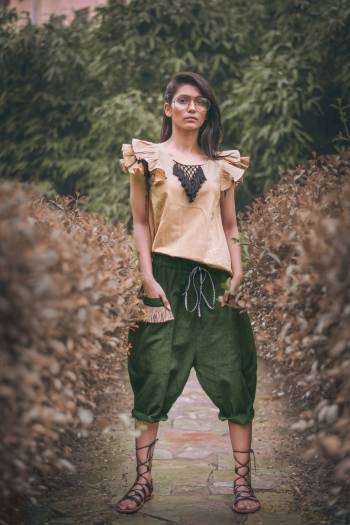 Olive Green Colored khadi  calf length pant with two outer pocket embellished with jute lace Paired With beige frill sleeves top with hand made tringle path lace 