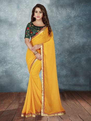 Celebrate This Festive Season Wearing This Traditional Combination With This Designer Saree In Orange Color Paired With Contrasting Dark Green Colored Blouse. This Saree Is Fabricated On Chiffon Georgette Paired With Art Silk Fabricated Blouse. 