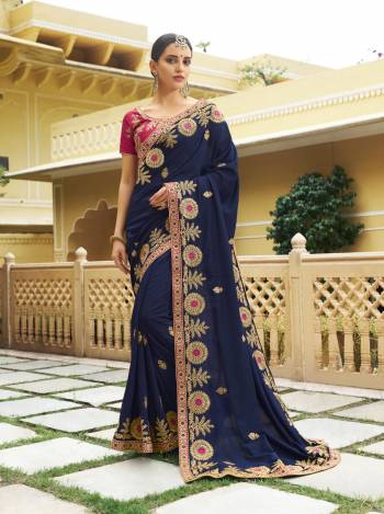 Enhance Your Personality Wearing This Designer Saree In Navy Blue Color Paired With Contrasting Dark Pink Colored Blouse. This Saree And Blouse are Silk Based Fabric Beautified With Attractive Embroidery All Over. Buy Now.