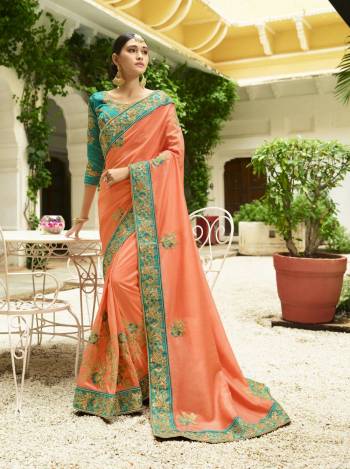 Very Pretty Designer Saree Is Here In Peach Color Paired With Contrasting Turquoise Blue Colored Blouse. This Saree Is Fabricated On Soft Silk Paired With Art Silk Fabricated Blouse. It Has Heavy Embroidery Over The Blouse And Lace Border With Embroidered Motifs all Over The Saree.