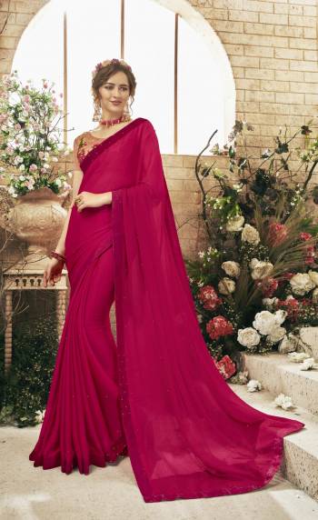 Bright and Visually Appealing Color Is Here With This Designer Saree In Dark Pink Color Paired With Peach Colored Blouse. This Saree Is Fabricated On Chiffon Paired With Art Silk Fabricated Blouse. It Has Heavy Embroidered Blouse With Stone And Pearl Work Over The Saree. Buy Now.