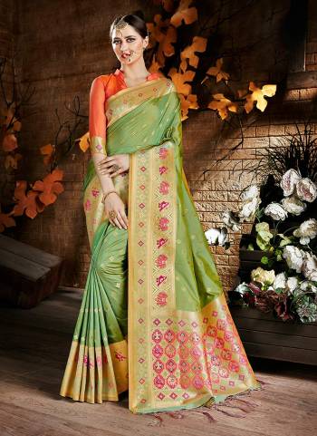 For A Proper Traditional Look, Grab This Silk Saree In Green Color Paired With Contrasting Orange Colored Blouse. This Saree And Blouse Are Fabricated On Cora Art Silk Beautified With Floral Weave. Buy Now.