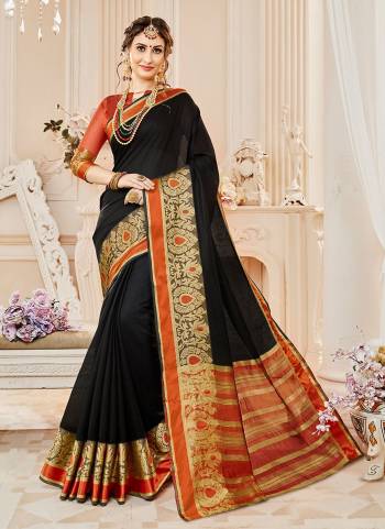 Have A Bold And Beautiful Look Wearing This Saree In Black Color Paired With Rust Orange Colored Blouse. This Saree And Blouse Are Fabricated On Cotton Silk Beautified With Weave Over The Border. Buy This Saree Now.