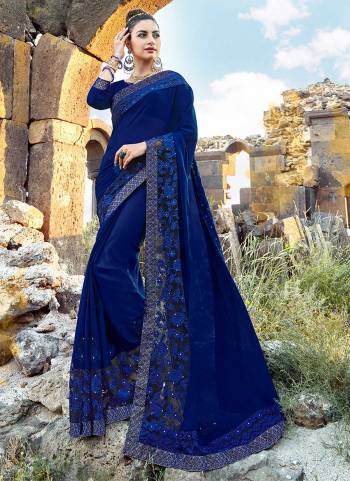 Add This Beautiful Designer Saree To Your Wardrobe In Dark Blue Color Paired With Dark Blue Colored Blouse. This Saree Is Fabricated On Georgette Paired With Art Silk Fabricated Blouse. It Has Pretty Tone To Tone Embroidery Over The Lace Border.