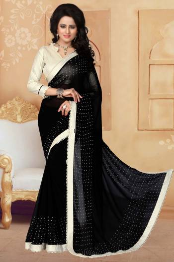 Grab This Elegant Looking Designer Saree For Your Semi-Casual Or Even Party Wear. This Saree Gives An Elegant And Simple Look Which Is Fabricated On Georgette. This Saree Is In Black Color Paired With Cream Colored Blouse. Buy This Saree Now.